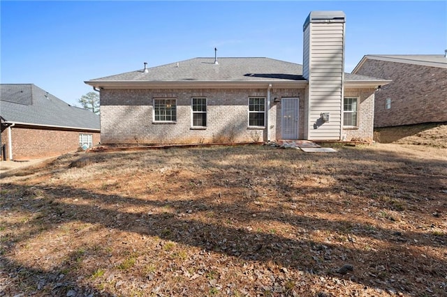 rear view of house with a yard