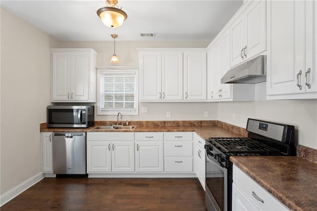 kitchen with stainless steel appliances, sink, and white cabinets