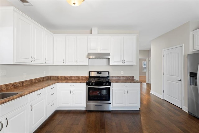 kitchen featuring dark hardwood / wood-style flooring, sink, stainless steel appliances, and white cabinets