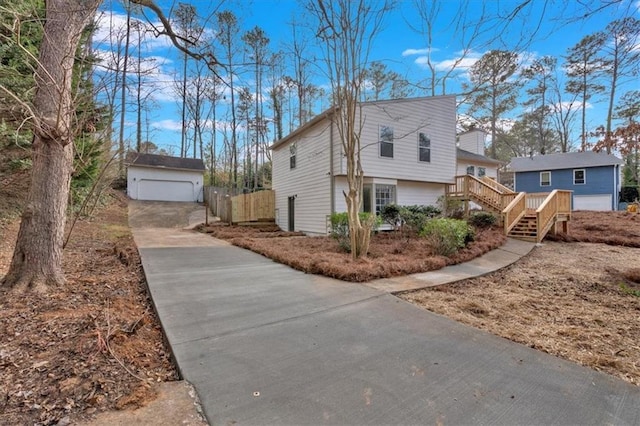 view of home's exterior with a garage and an outdoor structure