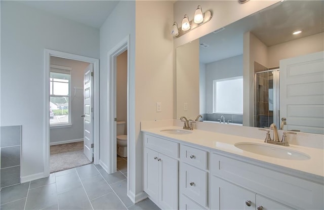 bathroom with tile patterned flooring, toilet, double vanity, and a shower with shower door