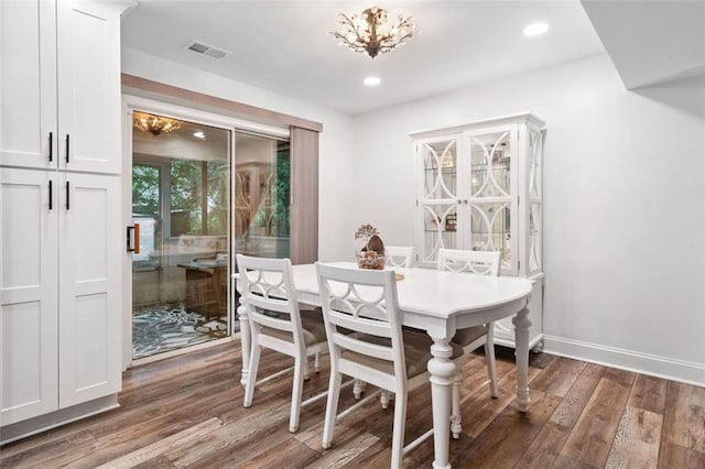 dining space featuring hardwood / wood-style flooring, a chandelier, baseboards, and recessed lighting