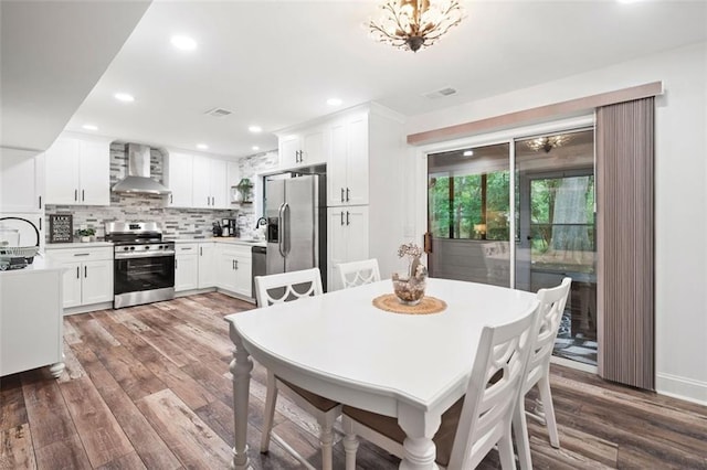 dining space featuring wood finished floors and recessed lighting