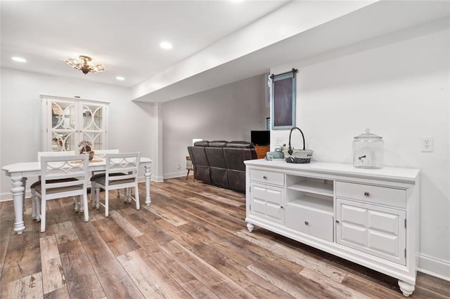 dining room with hardwood / wood-style floors, baseboards, and recessed lighting