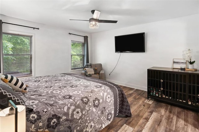 bedroom featuring wood finished floors, ceiling fan, and baseboards