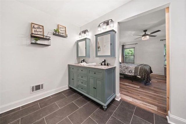 bathroom featuring connected bathroom, baseboards, tile patterned floors, ceiling fan, and double vanity