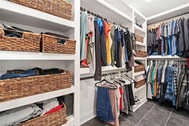 spacious closet featuring dark tile patterned flooring