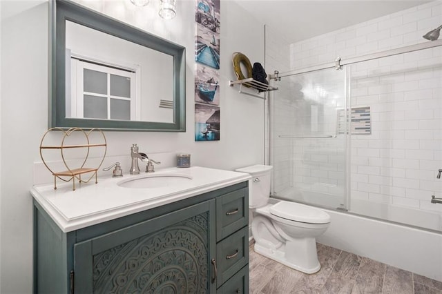 bathroom with vanity, toilet, and enclosed tub / shower combo