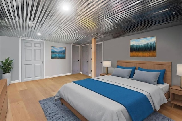 bedroom with wood finished floors and baseboards
