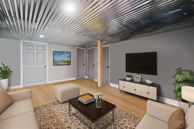 living room featuring wood finished floors and baseboards