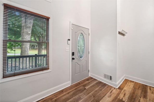 foyer entrance with wood finished floors and baseboards