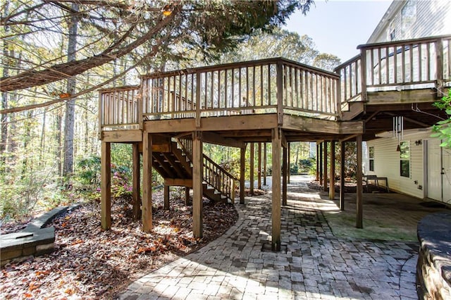 exterior space with stairway, a deck, and a patio