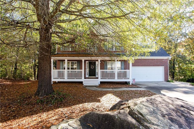 view of front of property with a garage, driveway, a shingled roof, a porch, and brick siding