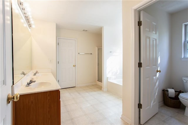 bathroom featuring a bath, a sink, toilet, and tile patterned floors