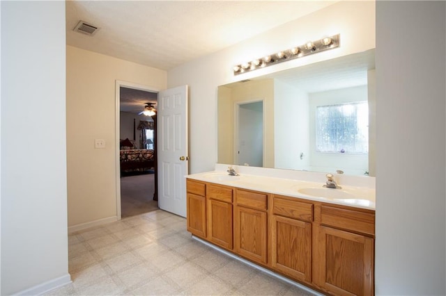 bathroom with double vanity, visible vents, ensuite bathroom, tile patterned floors, and a sink