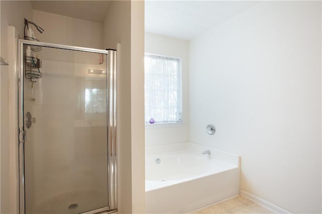 bathroom with a garden tub and a shower stall