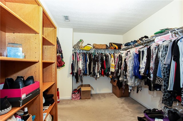 spacious closet with carpet floors and visible vents