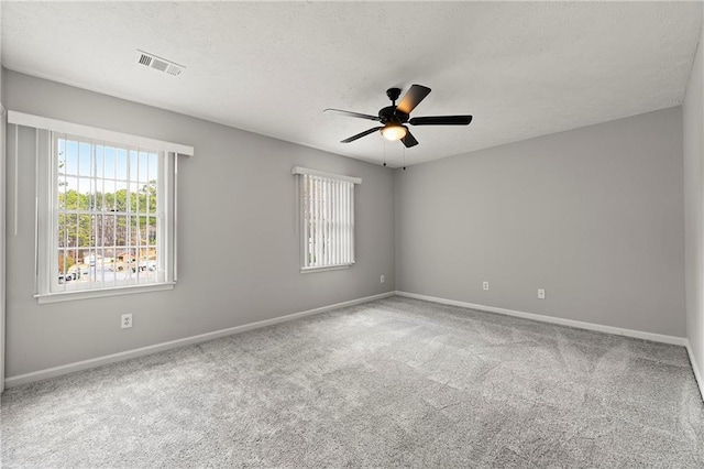 unfurnished room featuring ceiling fan, carpet flooring, and a textured ceiling