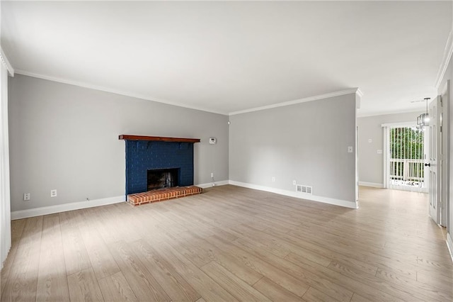 unfurnished living room featuring ornamental molding, a fireplace, a chandelier, and light hardwood / wood-style flooring