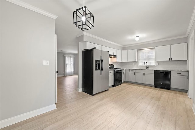 kitchen featuring pendant lighting, backsplash, ornamental molding, black appliances, and white cabinets