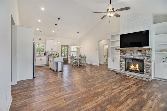 461 Barnwood Dr, Rockmart, GA 30153 - living room with ceiling fan, a fireplace, dark wood-type flooring, baseboards, and high vaulted ceiling