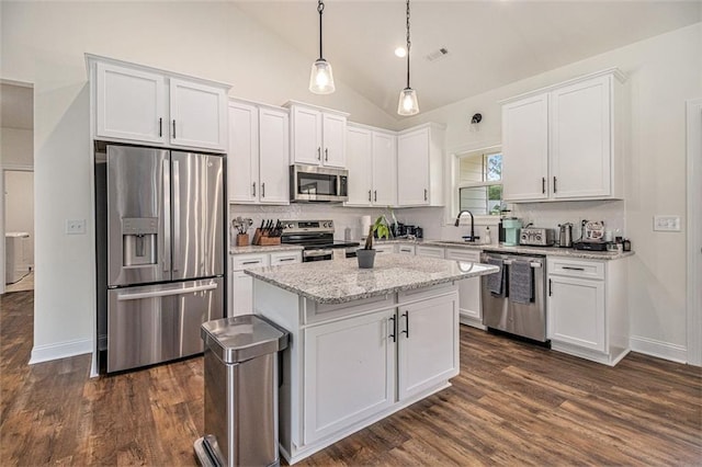 461 Barnwood Dr, Rockmart, GA 30153 - kitchen featuring appliances with stainless steel finishes, a sink, white cabinetry, dark wood finished floors, and a kitchen island