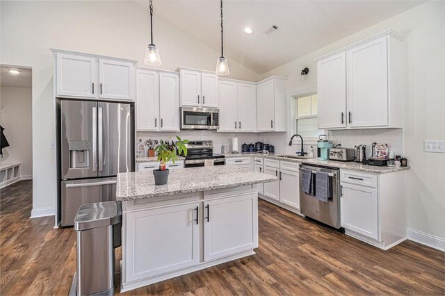 461 Barnwood Dr, Rockmart, GA 30153 - kitchen featuring stainless steel appliances, a sink, white cabinetry, vaulted ceiling, and recessed lighting