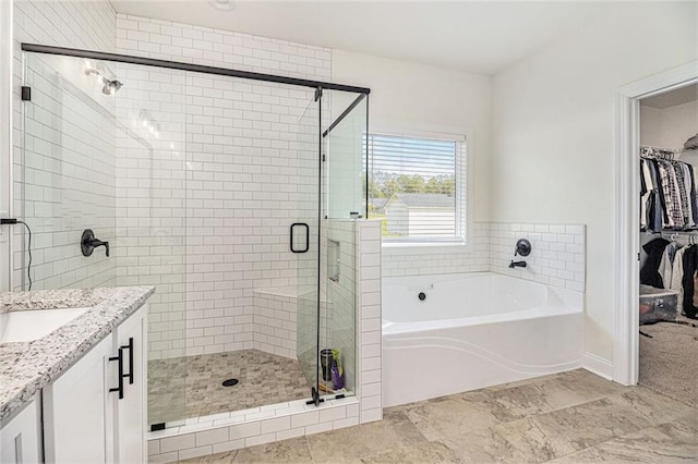 461 Barnwood Dr, Rockmart, GA 30153 - bathroom with a garden tub, a shower stall, a walk in closet, and vanity