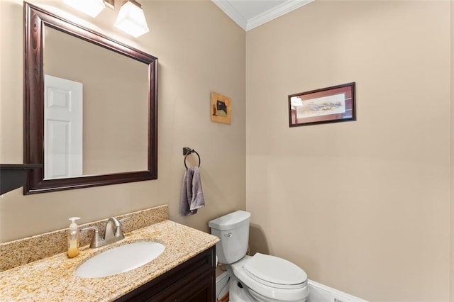 bathroom with crown molding, toilet, and vanity