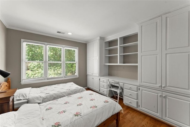 bedroom featuring crown molding, wood finished floors, and recessed lighting