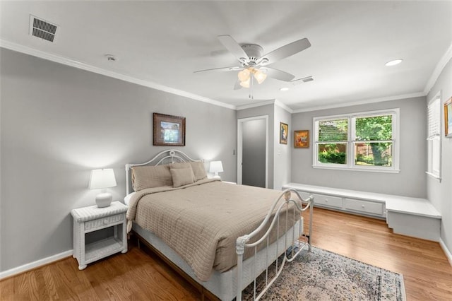 bedroom with wood finished floors, baseboards, ceiling fan, recessed lighting, and ornamental molding