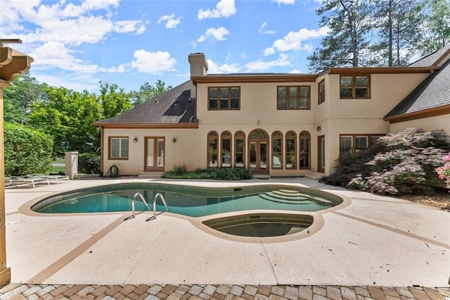 outdoor pool featuring french doors and a patio area