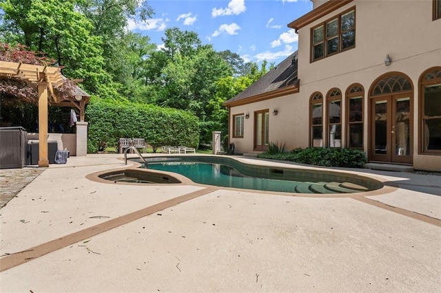 view of pool with french doors and a patio area
