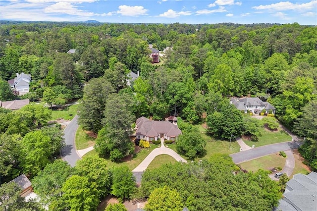 aerial view of property's location featuring a forest