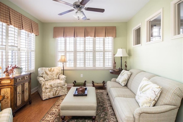 living room featuring ceiling fan and hardwood / wood-style flooring