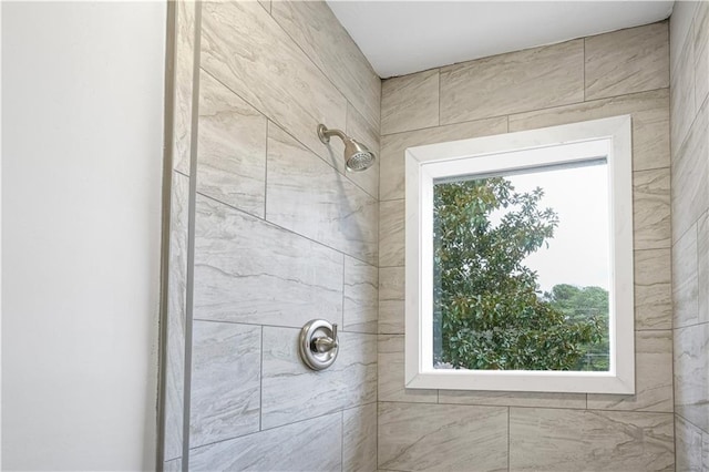 full bath with a tile shower