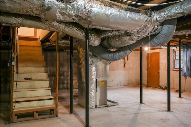 unfinished basement featuring heating unit