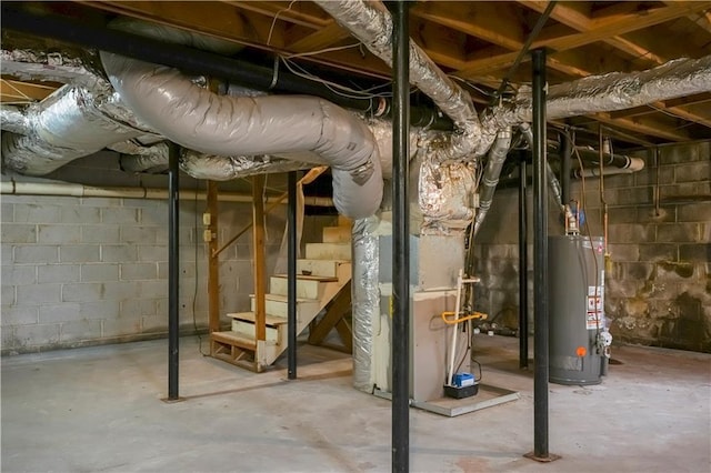 unfinished basement with stairs and gas water heater