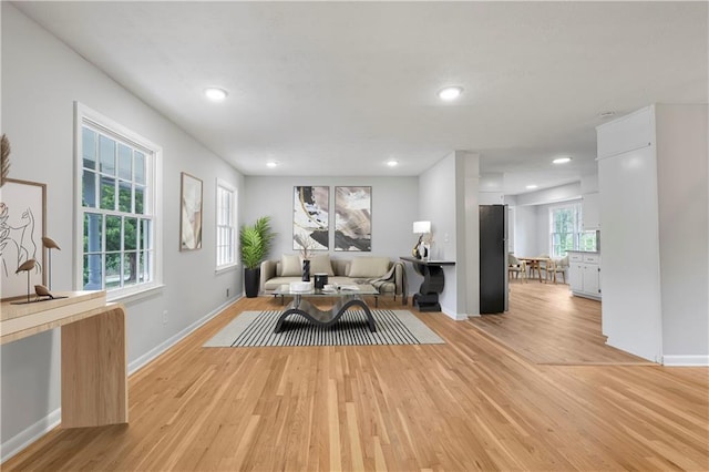 unfurnished living room featuring light wood-style floors, recessed lighting, and baseboards