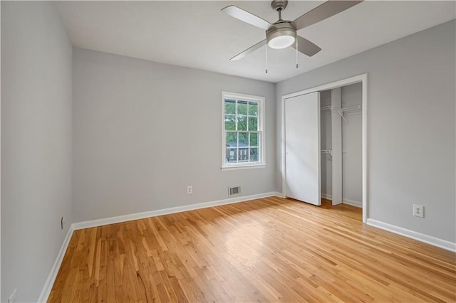 unfurnished bedroom with light wood-style flooring, a closet, visible vents, and baseboards