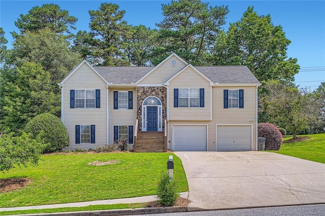 3290 Spincaster Way, Loganville, GA 30052 - bi-level home featuring a garage, concrete driveway, and a front lawn