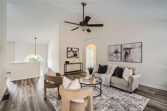 3290 Spincaster Way, Loganville, GA 30052 - living area featuring dark wood finished floors, high vaulted ceiling, arched walkways, and a ceiling fan