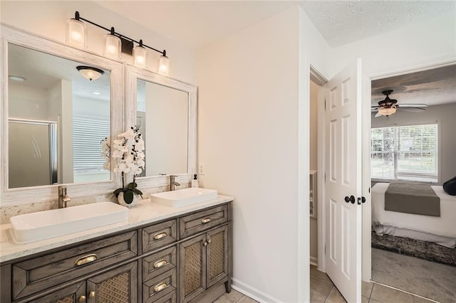 3290 Spincaster Way, Loganville, GA 30052 - ensuite bathroom with tile patterned floors, double vanity, a stall shower, and a ceiling fan