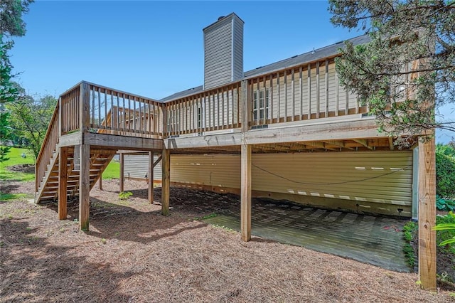 3290 Spincaster Way, Loganville, GA 30052 - rear view of house featuring stairway, a wooden deck, and a chimney