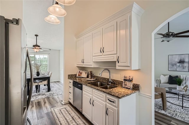 3290 Spincaster Way, Loganville, GA 30052 - kitchen featuring appliances with stainless steel finishes, ceiling fan, wood finished floors, and white cabinets
