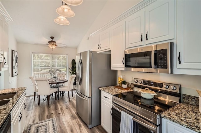 3290 Spincaster Way, Loganville, GA 30052 - kitchen featuring stainless steel appliances, lofted ceiling, white cabinets, ceiling fan, and light wood finished floors