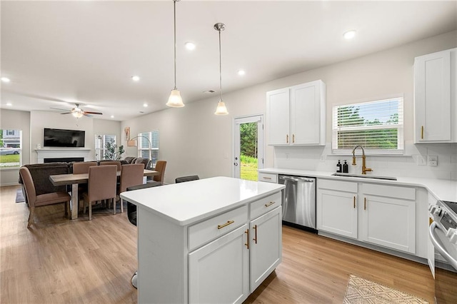 228 Whitneys Way, Dallas, GA 30157 - kitchen with appliances with stainless steel finishes, a sink, ceiling fan, recessed lighting, and a kitchen island