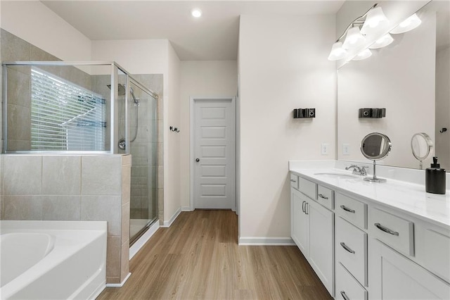 228 Whitneys Way, Dallas, GA 30157 - full bath featuring vanity, a shower stall, wood finished floors, a bath, and baseboards