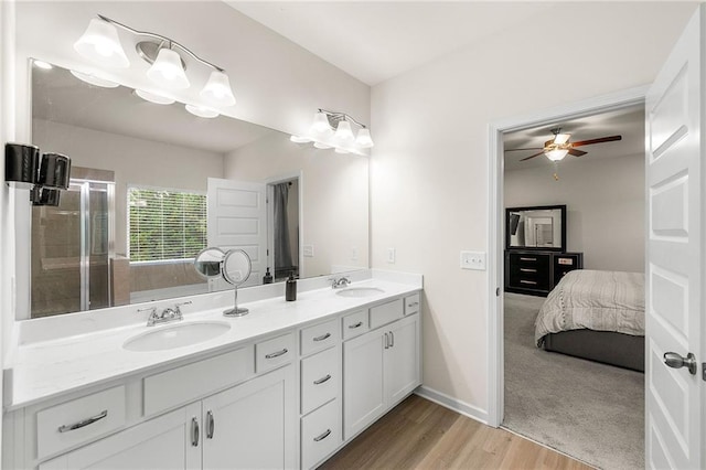 228 Whitneys Way, Dallas, GA 30157 - ensuite bathroom with double vanity, wood finished floors, a shower with door, a ceiling fan, and baseboards