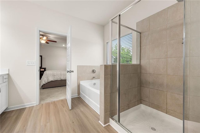 228 Whitneys Way, Dallas, GA 30157 - ensuite bathroom with wood finished floors, a bath, a stall shower, and vanity